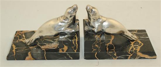 A pair of French Art Deco silvered bronze and marble seal bookends, 6in.